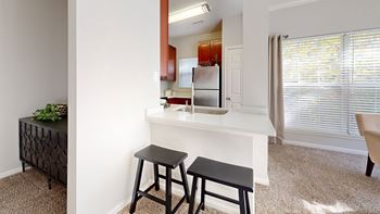 A kitchen with a counter and two stools